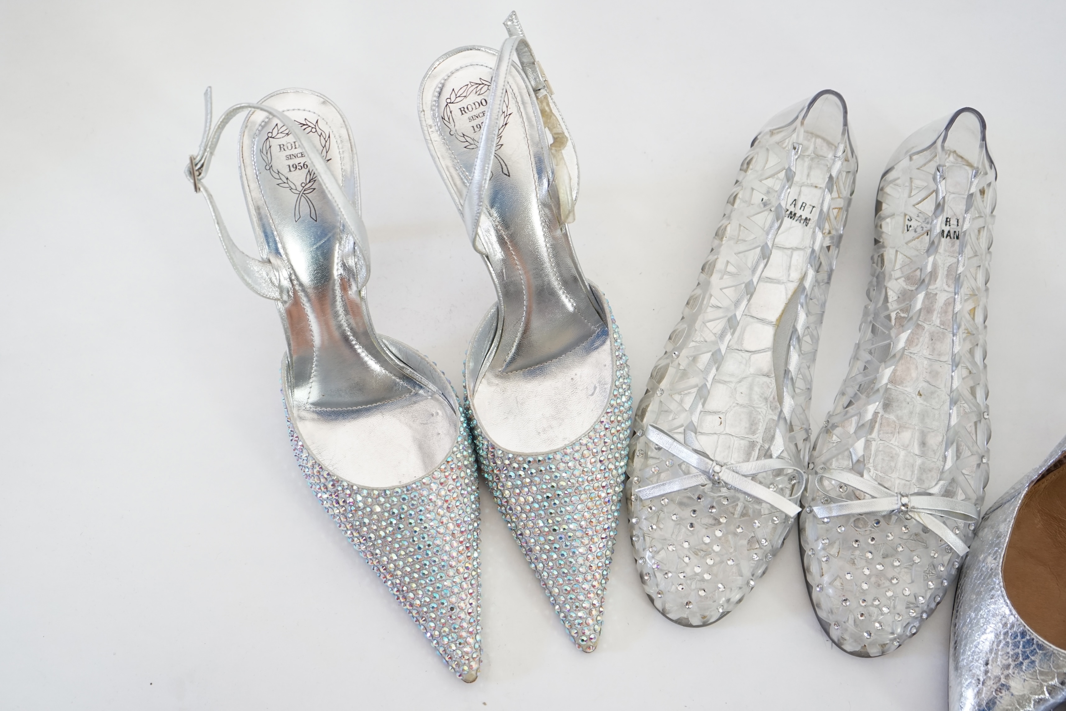 Three pairs of lady's silver shoes: Rodo silver diamonté sling back heels, Moda in Pelle silver snakeskin pattern heeled pumps and a pair of Stuart Weitzman clear jelly's with crystals. Size 38.5 (UK 4). Proceeds to Happ